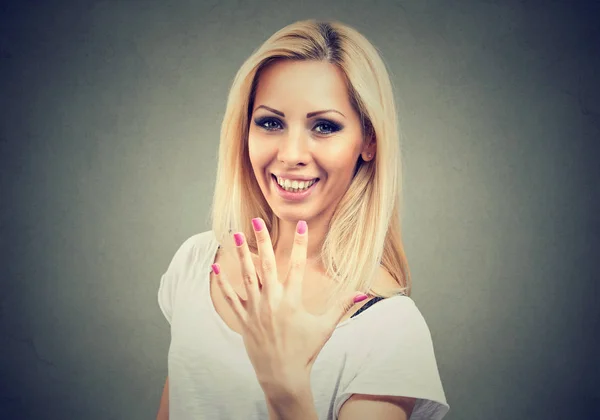 Возбужденная молодая женщина показывает свой идеальный маникюр или пять пальцев жест — стоковое фото