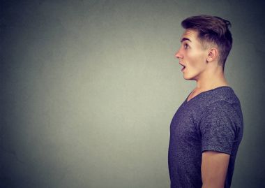 Side profile of a shocked young man clipart