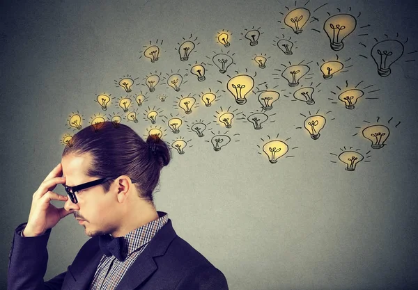 Man wearing glasses having many ideas thinking organizing thoughts — Stock Photo, Image