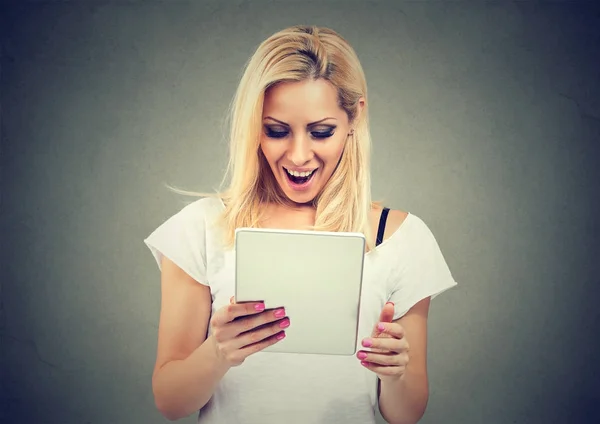 Excited woman watching tablet — Stock Photo, Image