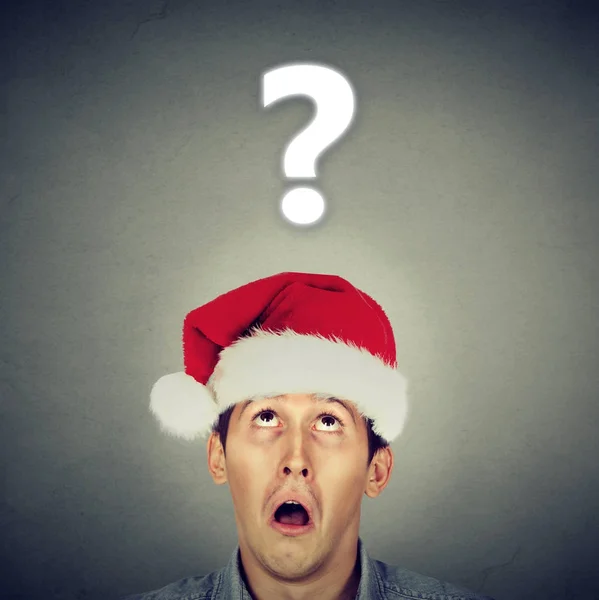 Man in Santa hat questioning about gifts — Stock Photo, Image
