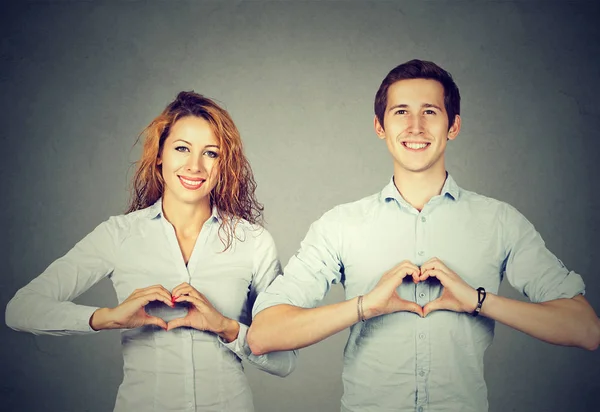 Cheerful people showing hearts with hands — Stock Photo, Image