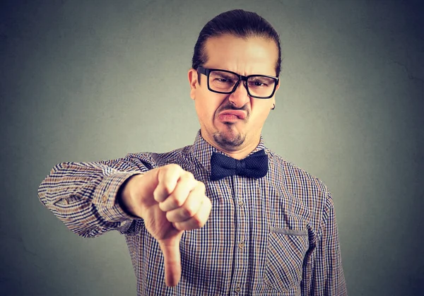 Man showing thumb down in disgust — Stock Photo, Image