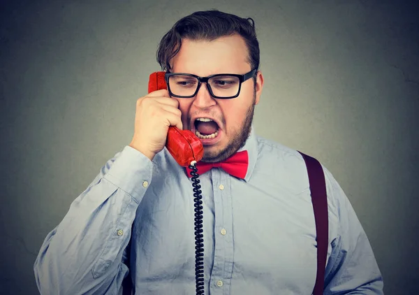 Angry chunky man talking on phone — Stock Photo, Image