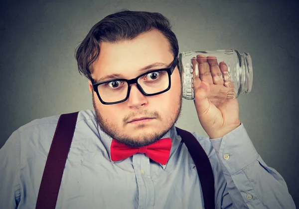 Man using jar while eavesdropping — Stock Photo, Image