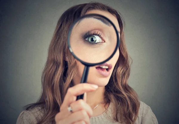 Woman looking through magnifier — Stock Photo, Image