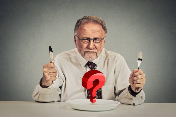 Senior perplexed man choosing meal