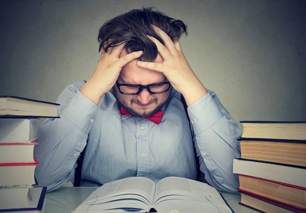 Student young man with desperate expression looking at books — Stock Photo, Image