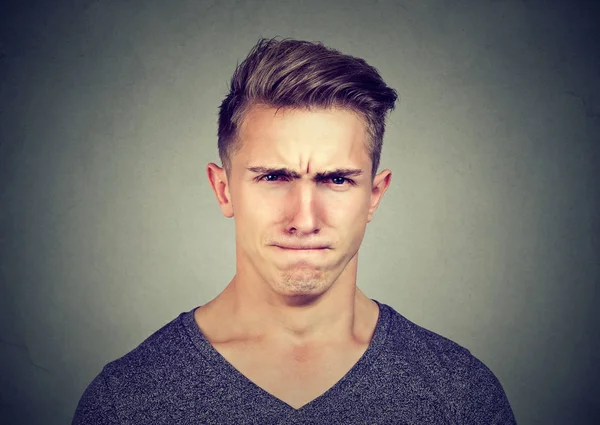 Young man full of hatred looking pissed off and annoyed — Stockfoto
