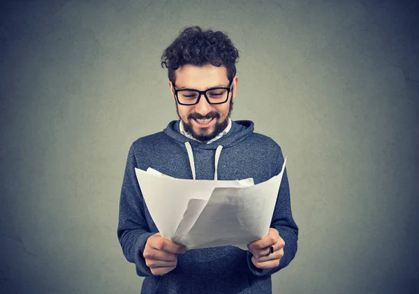 Cheerful man with papers on gray — Stock Photo, Image