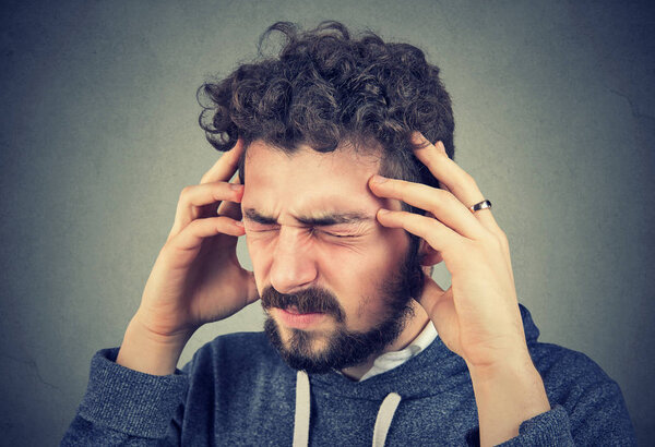 Молодой человек, страдающий хеадахе
