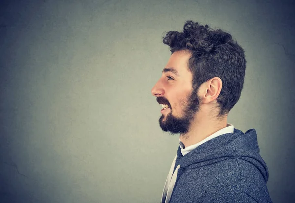 Casual handsome man smiling on gray — Stock Photo, Image