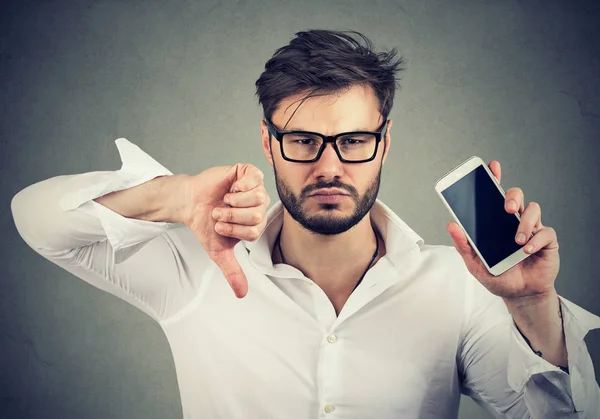 Man dissatisfied with quality of gadget mobile phone — Stock Photo, Image