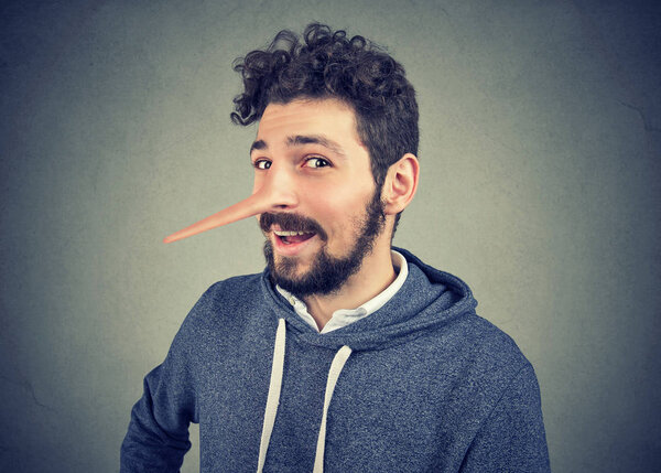 Liar man with long nose isolated on gray background. 