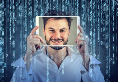 Man holding tablet with his face displayed on a screen on binary code background  clipart