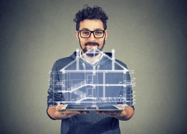 Bearded man using portable electronic pro tablet showing new home project — Stock Photo, Image