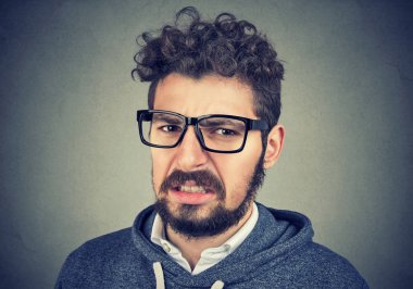 Disgusted male feels aversion towards something clipart