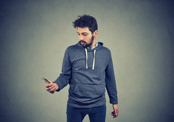 Serious guy using a smartphone — Stock Photo, Image