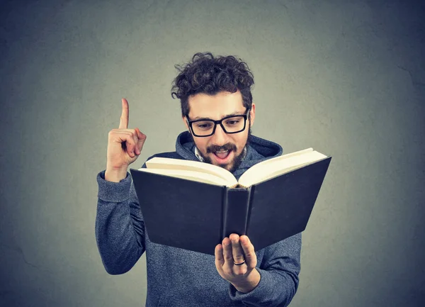 Excited hipster guy reading a book — Stock Photo, Image