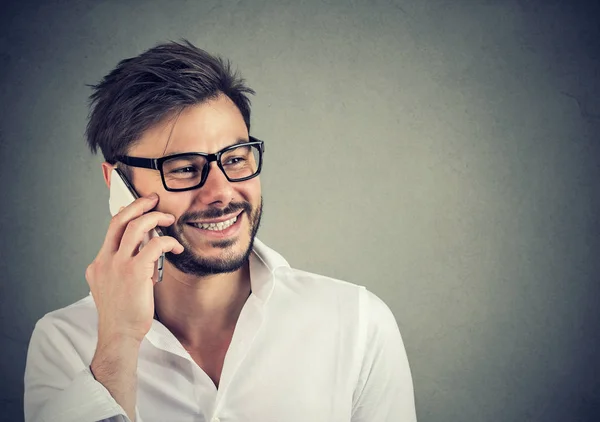 Handsome man speaking on the phone happily — Stock Photo, Image