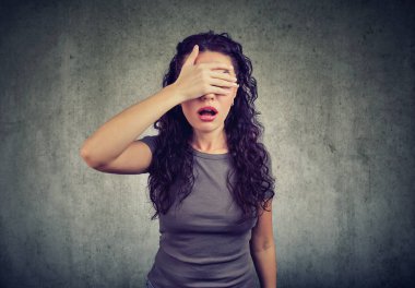 Regretful woman covering her eyes clipart