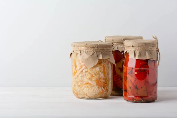 腌制的发酵卷心菜 西红柿 胡萝卜 混合在一个玻璃瓶中 在白色木制桌子上的罐头 站直了 — 图库照片