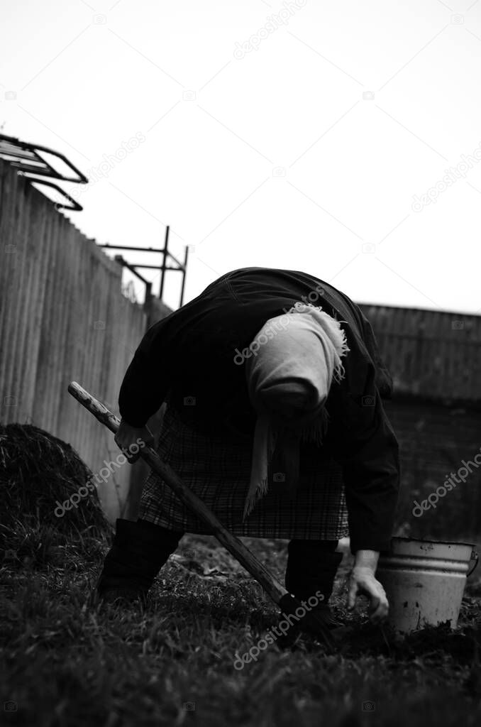 Black-and-white photograph of grandma digging