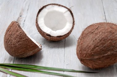 Gri ahşap bir masada hindistan cevizi. Yarım hindistan cevizi.