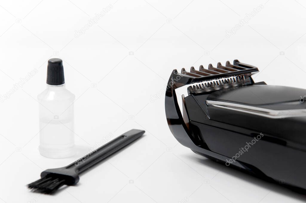 Trimmer, oil and brush on a white isolated background. Beard Care.