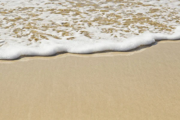 Ola espumosa en una costa limpia y arenosa —  Fotos de Stock
