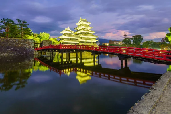 Night view of the Matsumoto Castle (or Crow Castle) and bridge, in Matsumoto, Japan