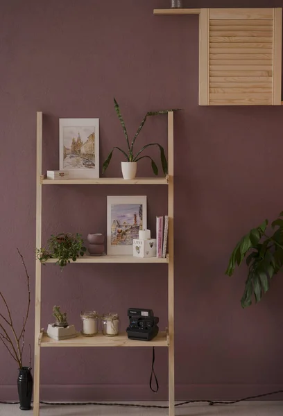 Wooden staircase shelf with interior details and plants on a lavender background