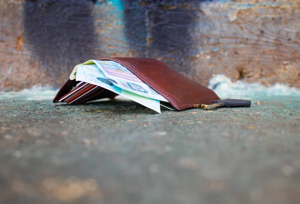 fallen wallet on street with money inside. concept lose wallet