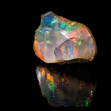 Precious opal. Gemological sample, no cut.Very bright unique sample is photographed on a black background with reflection. The only one treatment - dust was removed from background. clipart