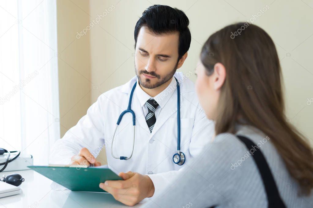 Serious doctor explaining diagnosis to her female patient in med
