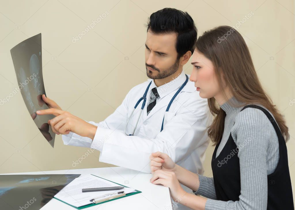 Doctor having conversation with his patient and explaining skele