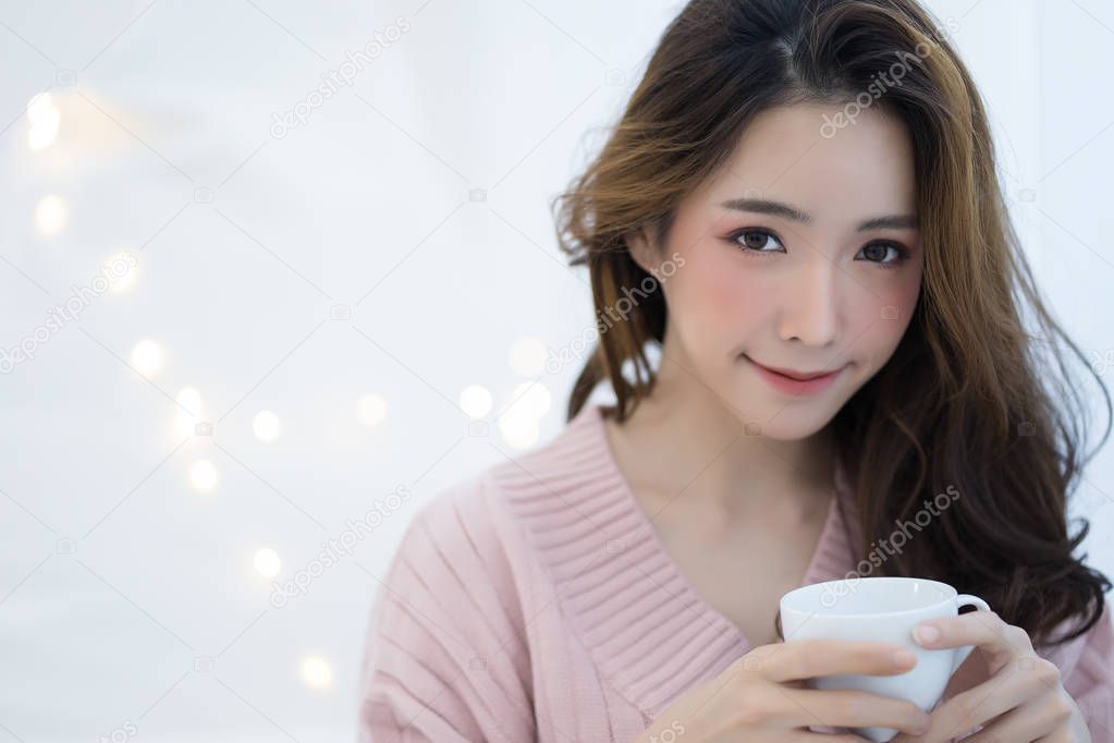 Portrait of young smiling asia woman in warm knitted handmade cl
