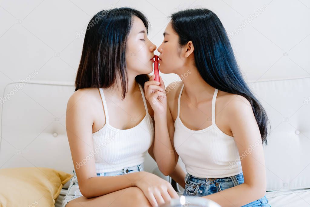 Romantic lesbian couple kiss lips. Lesbian in love kissing while