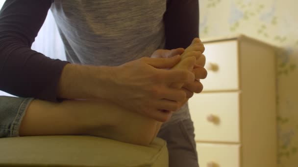 Χέρια ενός άντρα που κάνει μασάζ στα πόδια. — Αρχείο Βίντεο