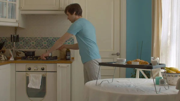 Young Man Kitchen Preparing Breakfast Taking Cezve Fire Plate Croissant — Stock Photo, Image