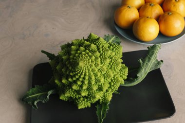 Karnabahar ve portakallar sağlıklı yemekler için yemek masasında.