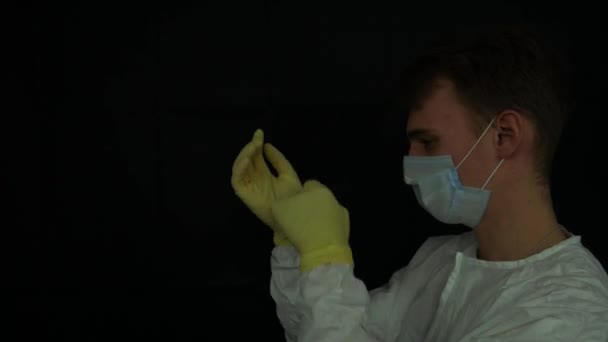 Young Caucasian Man Takes His Double Protective Gloves — Stock Video