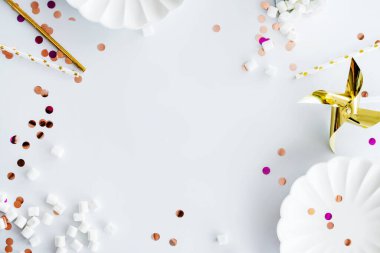 Beyaz, altın ve pembe dekorasyonlardan yapılmış çerçeve, şeker, çubuk, tabak, konfeti doğum günü için ya da kızlar için bekarlığa veda partisi ya da bebek partisi için. Düz yatış, üst görünüm