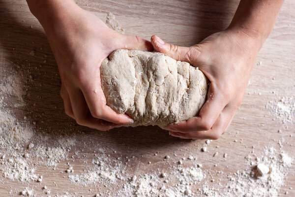 Working hands kneading bread gluten free dough