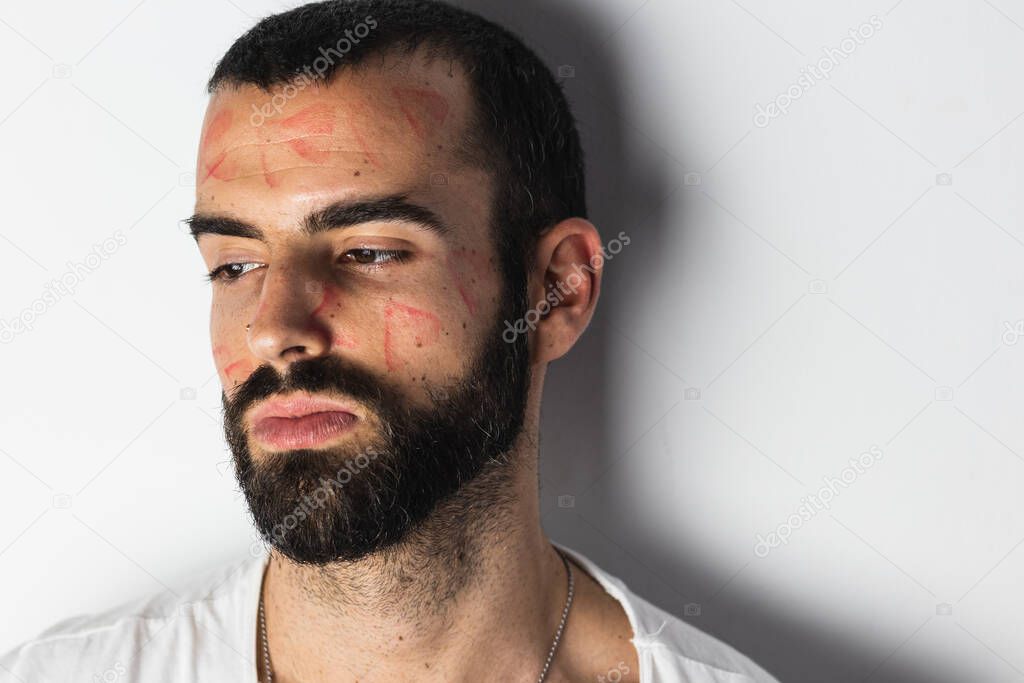 Handsome man with traces of lipstick on his face