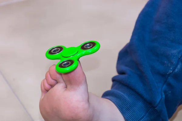 Boy playing with fidget spinner gadget