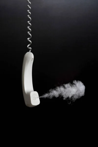 Smoke coming out from hanging telephone receiver