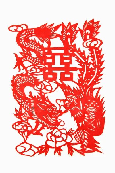 Traditional chinese red paper cutting of dragon and phoenix