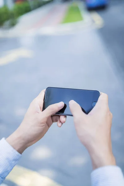 Man playing game on mobile phone