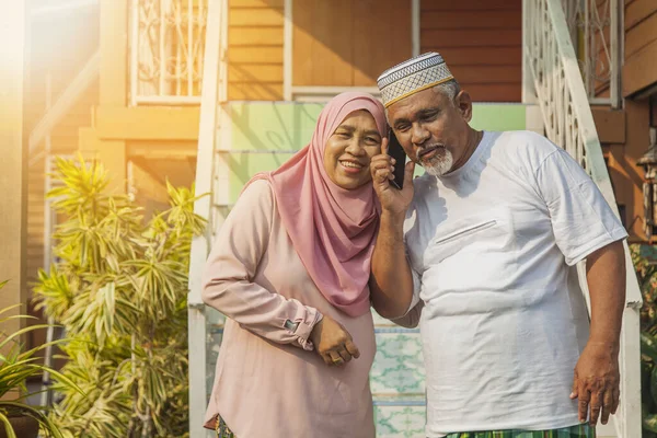 Senior couple listening to a call on mobile phone